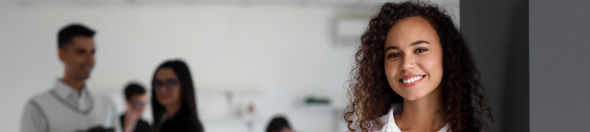 Young African-American woman with clipboard in office